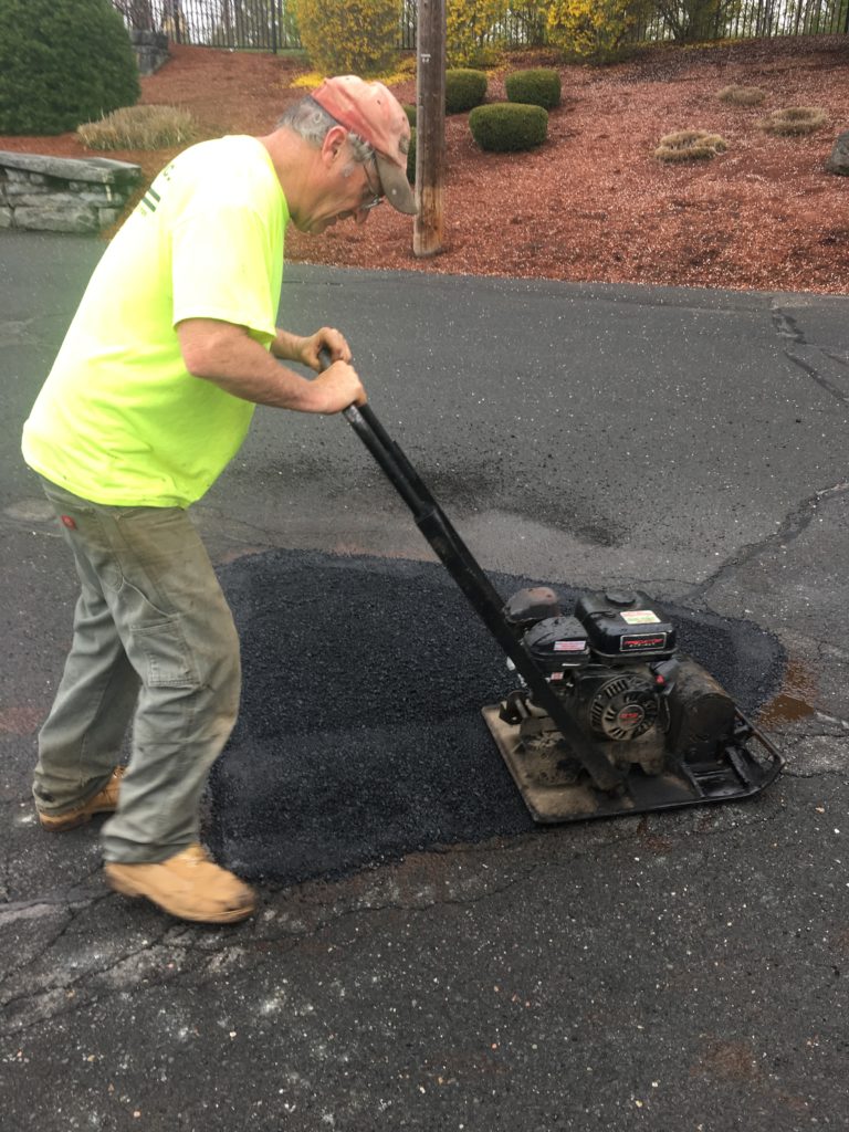 Hartline employee repairing a pot hole